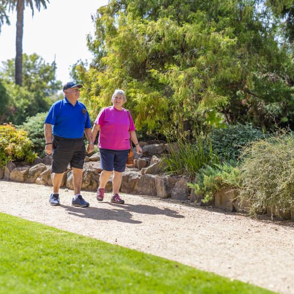Image of two senior people on a walk in the park